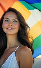 Wall Mural - A woman with long black hair is standing in front of a rainbow flag