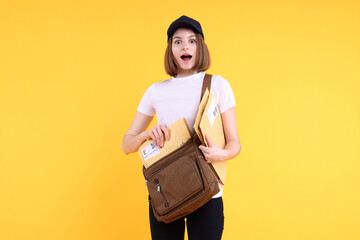 Poster - Emotional postwoman with bag and envelopes on yellow background