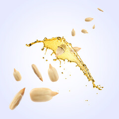 Wall Mural - Cooking oil splash and flying sunflower seeds on light blue background