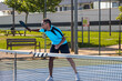© ivan - Pickleball player preparing to hit the ball during a match
