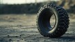 © Cyber Shutter - Rustic close-up of a rugged rubber tire on a construction site under natural light showcasing wear and durability against a dusty backdrop