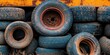 © Ahmad - Rusty stack of worn blue rubber tires arranged in a pile with an orange background highlighting rural recycling and vintage machinery aesthetics.