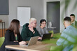 © .shock - A diverse multiethnic business team engages in a collaborative meeting, discussing strategies and solutions in a modern office setting