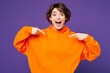 © ViDi Studio - Young shocked surprised excited cool fun happy Caucasian woman she wear orange hoody casual clothes point index finger on herself isolated on plain purple background studio portrait Lifestyle concept