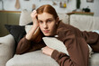 © Bliss - A handsome redhead with long hair relaxes in his stylish apartment, savoring the moment.