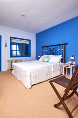 Wall Mural - Blue hotel room interior concept, white bed and bathroom style.