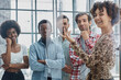 © Katsiaryna - a team of young designers sticking notes on glass in a modern office
