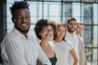 © Katsiaryna - Portrait of smiling African American business man with executives working in background