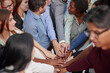 © Katsiaryna - Multiethnic college students fold their hands in place