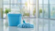 © red_orange_stock - Bright, clean floor showcases a blue mop and bucket, ready for cleaning tasks in a spacious environment illuminated by natural light