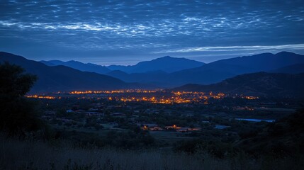 Wall Mural - Serene Nighttime View of a Quiet Town Surrounded by Mountains