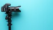 © STwul - DSLR camera on tripod, blue background, copy space, photography
