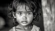 © Bunlong - A grayscale portrait of a child with big eyes.