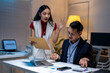 © Wasana - Stressed asian businessman having argument with furious boss showing business report with bad result at night