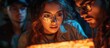© STwul - Young adults examine glowing map, dark room, escape room game