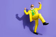 © deagreez - Photo of cheerful crazy glad man wear yellow fashionable costume celebrate empty space isolated on purple color background