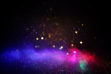 Wall Mural - abstract glitter red, pink, purple and gold lights background. de-focused