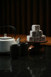 © Gecko Studio - Coffee pot and Turkish delight on a black background, selective focus