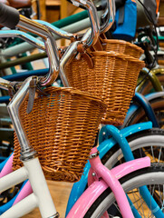 Colorful bicycles with stylish wicker baskets await adventure in a vibrant shop filled with unique designs