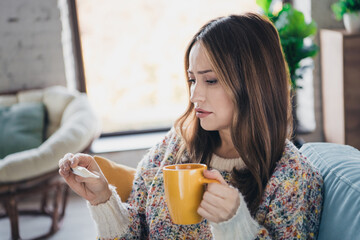 Wall Mural - Young Woman Relaxing Indoors on a Casual Day Holding a Cup