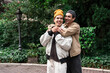 © ADDICTIVE STOCK - Affectionate embrace of a joyful gay couple in a serene park setting