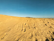 © Rendara Studio - Golden dune with hike text under blue sky