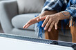 © Liubomir - Man hands close up near a heating device. Man tries to warm himself while sitting at home on a sofa in the living room, there is no heating in the apartment.