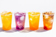 © Anna - Colorful drinks stacked on white background with ice during sunny day at outdoor gathering