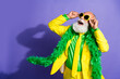 © deagreez - Portrait of funny extravagant aged man empty space ad yellow suit isolated on purple color background