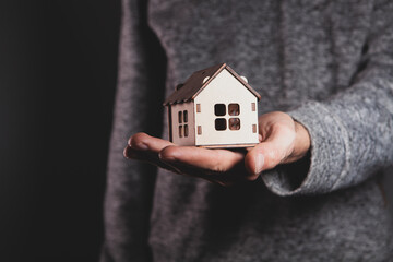 Wall Mural - a man holding a house model.