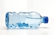 © Viktor - Light blue crumpled plastic water bottle lies on plain white background. Filled with clear water. Bottle isolated. Image highlights problem of plastic waste, pollution. Used to advocate for