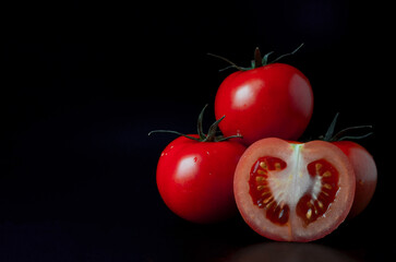 tomatoes on black background