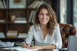 © PhotoProAD - A woman is sitting at a desk with a pen and a notebook