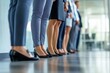 © SKIMP Art - A group of business people standing in line, close-up of hands holding the bottom of their legs, office background, blurred Generative AI