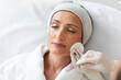 © Home-stock - Middle aged woman, wearing medical cap on head, receiving aesthetic facial treatment, beauty specialist giving her anti age injection shot in nasolabial skin fold