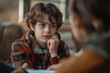 © PhotoProAD - A boy is sitting on a couch with his head on his hand