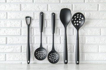 Kitchen utensils background with a blank space for a text and white brick background, home kitchen decor concept.