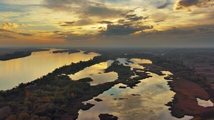 Wall Mural - aerial view landscape with beautiful sunset with dramatic sky reflection on danube river, 4k