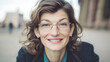 © Siasart Stock - Close-up Photo of Smiling Woman with Glasses in Blurred City Background