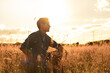 © kieferpix - thoughtful man sitting in a field at sunset