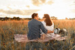 © kieferpix - Romantic couple in the park enjoying picnic watching the beautiful sunset, Love and relationships