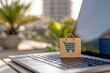 © Pojjanee - Shopping bag symbol on laptop keyboard with blurred background, representing online shopping convenience