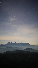 Wall Mural - night sky with moving stars above the northern landscape of chiang mai, thailand with the famous doi