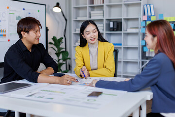 Wall Mural - Group of confident business people point to graphs and charts to analyze market data, balance sheet, account, net profit to plan new sales strategies to increase production capacity.	
