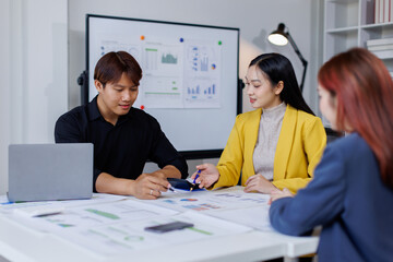 Wall Mural - Group of confident business people point to graphs and charts to analyze market data, balance sheet, account, net profit to plan new sales strategies to increase production capacity.	
