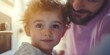 © Yan - A child with curly hair and big eyes is smiling, while an adult is softly smiling next to them. The scene feels warm and affectionate. Concept Candid Family Moments, Curly Hair Charm