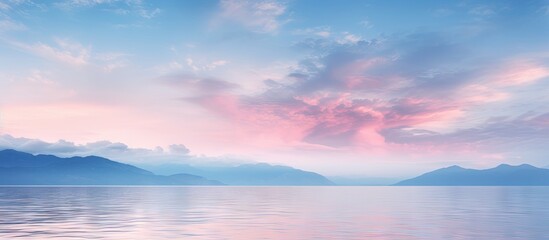 Wall Mural - serene twilight sky with soft pink and blue hues illuminating clouds over tranquil azure water refle