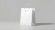© pixel - A white shopping bag on a black background with a green shopping bag nearby, mockup template