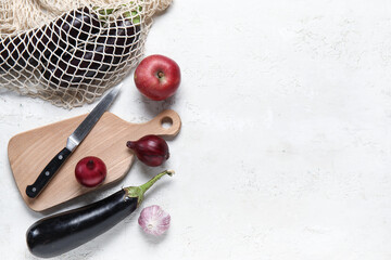 Canvas Print - Wooden board with knife and fresh products on grunge white kitchen table