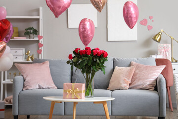 Wall Mural - Vase with bouquet of beautiful roses and gift box on coffee table in living room. Valentine's Day celebration